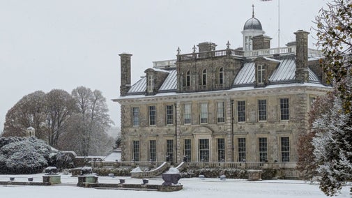 A grand stone mansion in the snow